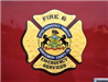 Fire and emergency services badge up close on side of truck