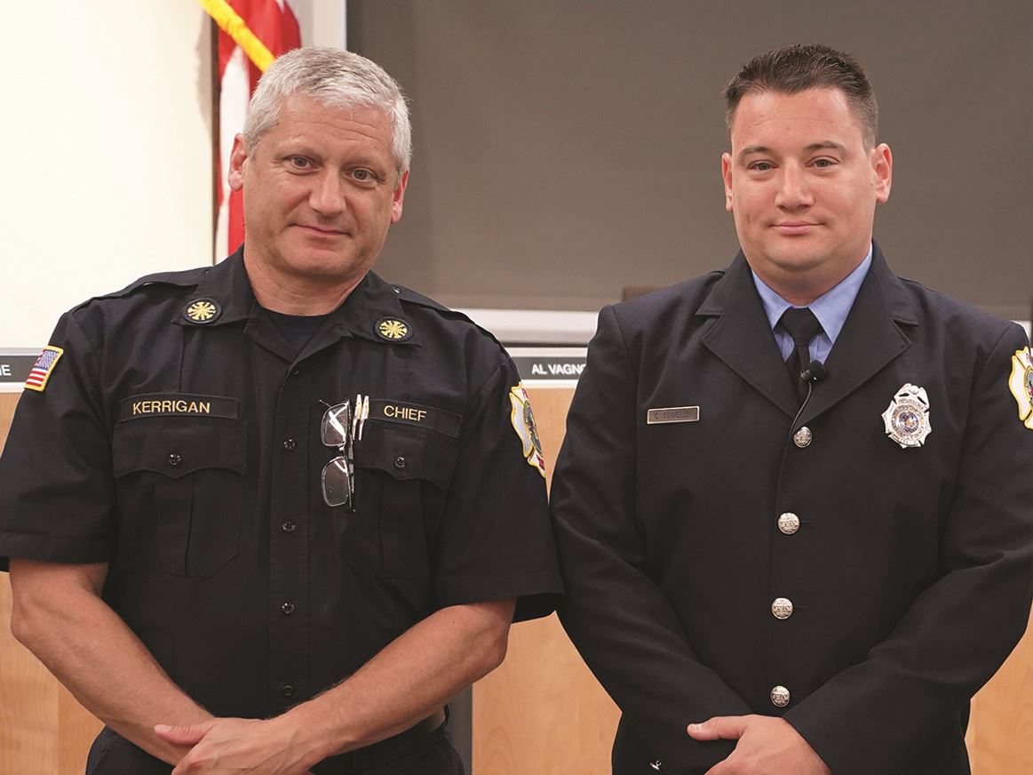 Newly sworn in firefighter/EMT standing with Fire